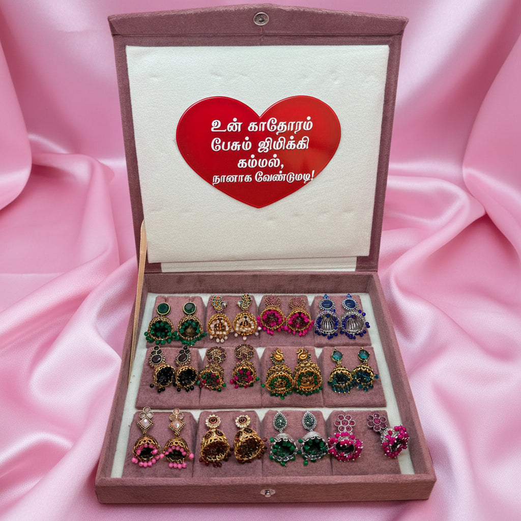 Box of earrings with a heart-shaped card on a pink background